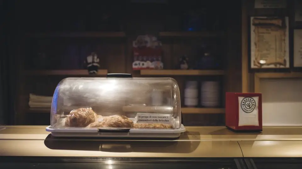 Mostrador de un restaurante con productos bajo una campana de vidrio